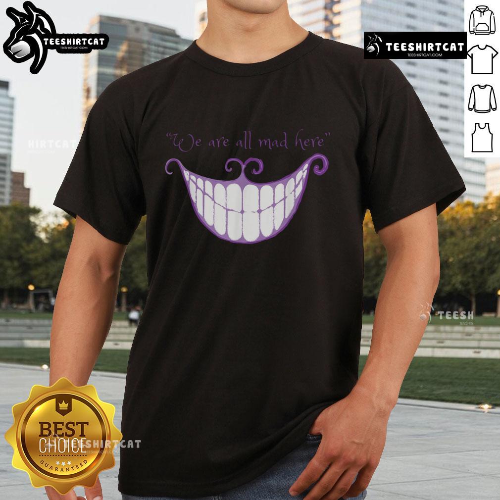 Cheshire Cat smile graphic on 'We Are All Mad Here' T-shirt, perfect for Alice in Wonderland fans.