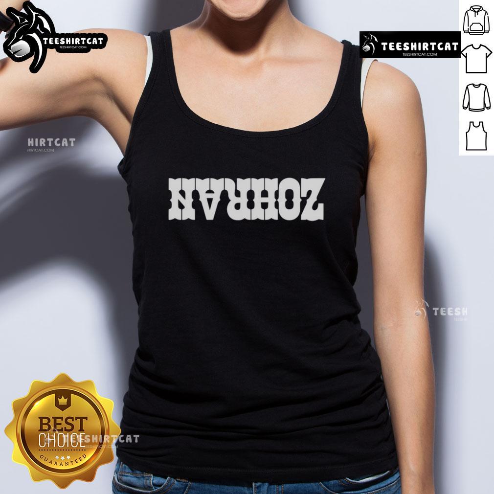 Lindsey Boylan smiles while wearing a stylish Zohran tank top, showcasing a trendy urban fashion style.