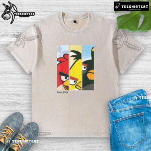 Alt Text: Retro Angry Birds character face panel design on a washed t-shirt featuring red, yellow, and black birds.