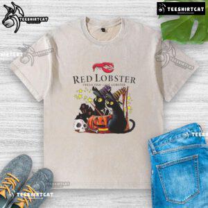 Official Red Lobster black cat witch pumpkin haunted house Halloween washed t-shirt design featuring spooky elements.