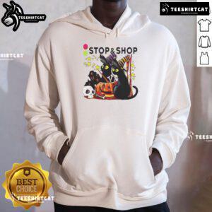 Alt Text: Black cat witch with a pumpkin in front of a haunted house on the Official Stop And Supermarket Halloween hoodie.