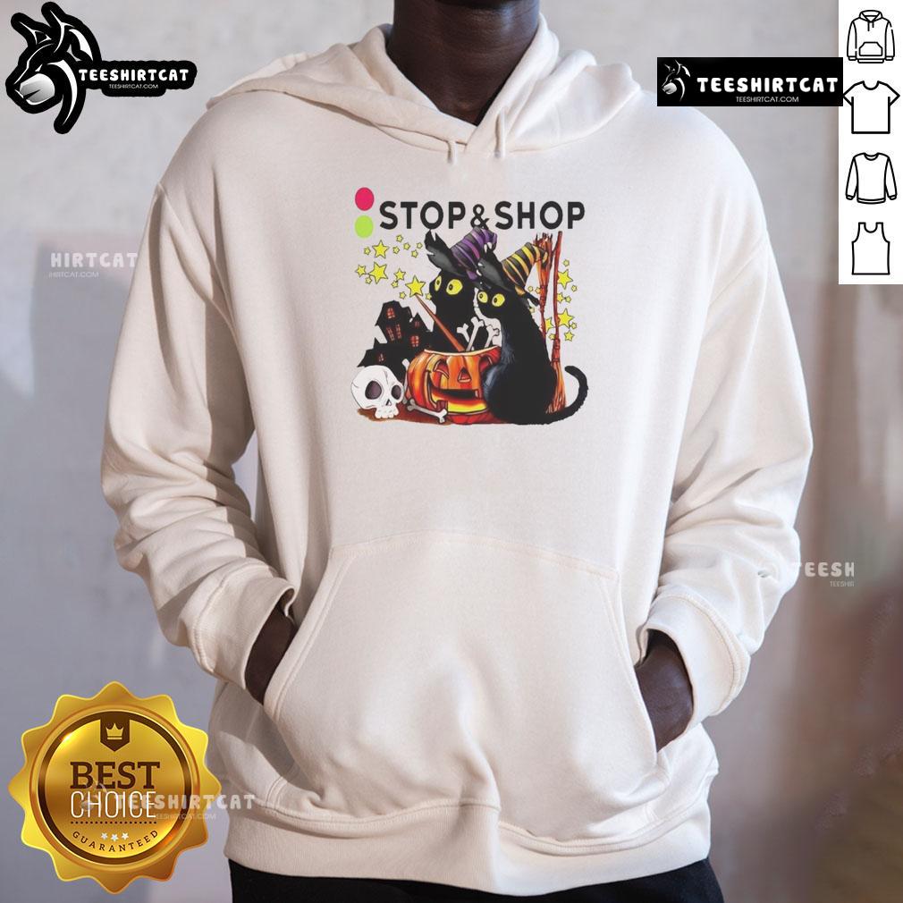 Alt Text: Black cat witch with a pumpkin in front of a haunted house on the Official Stop And Supermarket Halloween hoodie.