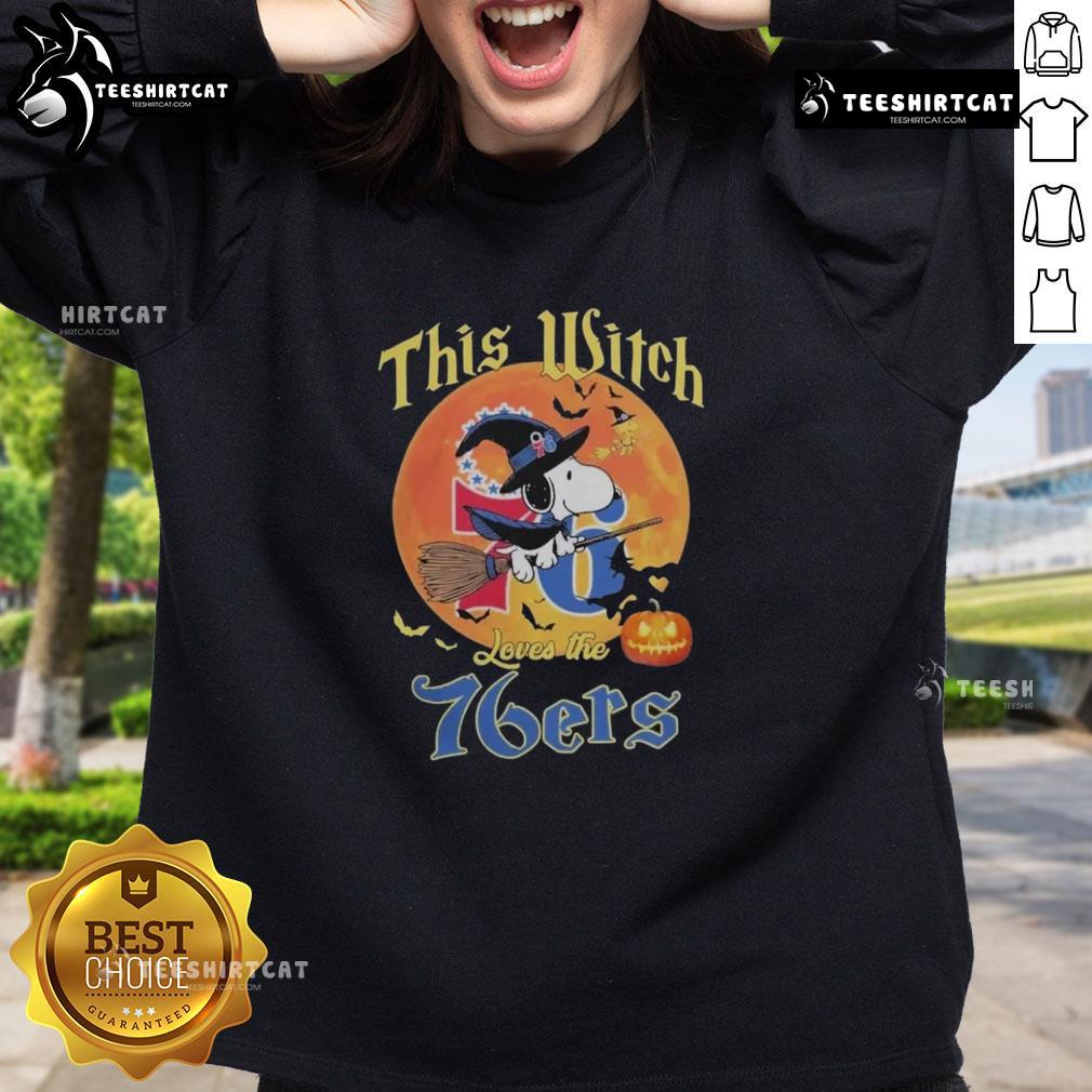Official This Witch Loves The Philadelphia 76ers Snoopy Halloween Sweatshirt featuring Snoopy in a witch hat and team colors.