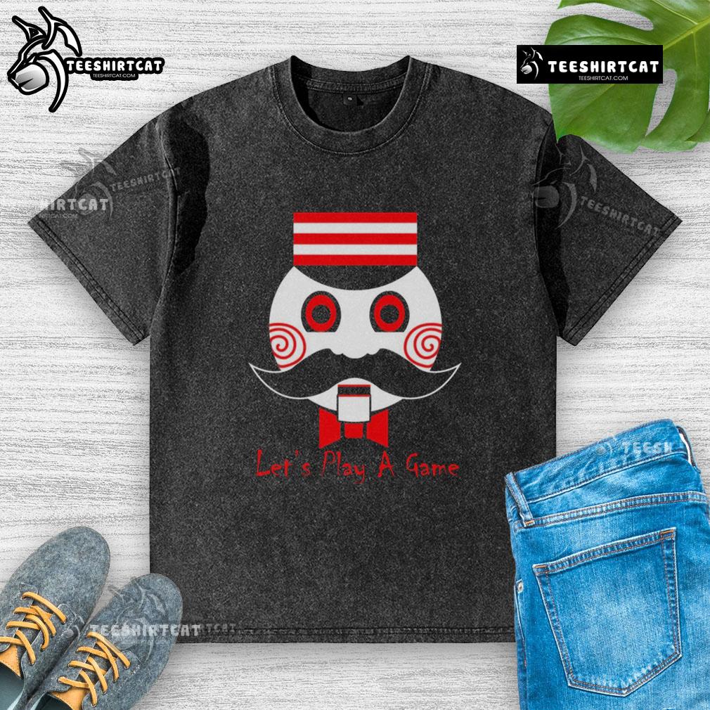 Premium Let's Play a Game Saw Movie washed t-shirt featuring a graphic design inspired by the iconic horror film.
