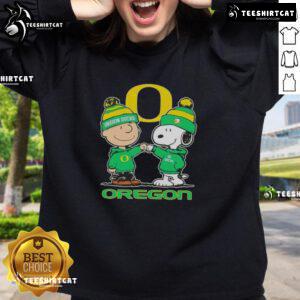 Premium Snoopy and Charlie Brown Oregon Ducks football skyline sweatshirt featuring vibrant graphics and cozy design.