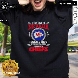 Person wearing a Kansas City Chiefs sweatshirt, showing team spirit despite living in Nevada on game day.