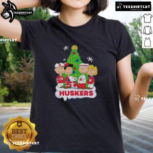 Good Peanuts characters on a Nebraska Cornhuskers Christmas ladies tee, perfect for holiday sports fans.