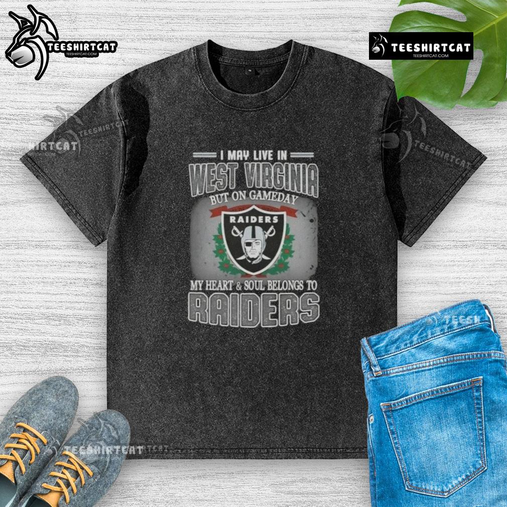Premium washed t-shirt featuring 'I May Live In West Virginia, But On Gameday My Heart Belongs To Raiders' design.