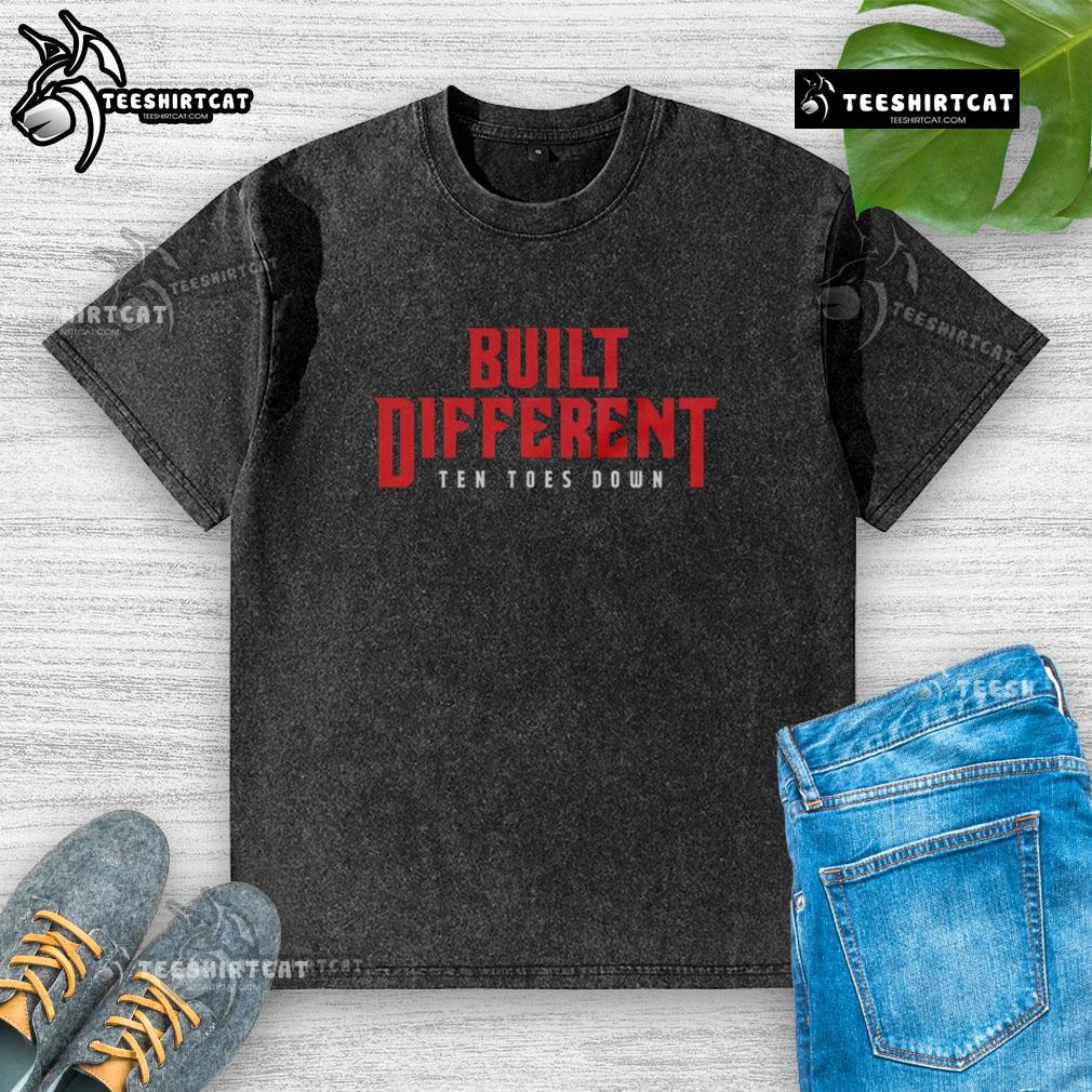 Top Built Different Ten Toes Down washed t-shirt displayed on a hanger, showcasing its casual style and soft fabric.