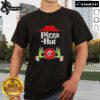 Top Grinch hands holding a pizza slice on a Merry Christmas T-Shirt from Pizza Hut, perfect for holiday celebrations.