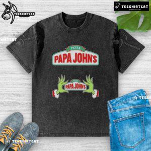 Top Grinch hands holding a pizza slice on a Merry Christmas washed T-shirt from Papa Johns, festive holiday design.