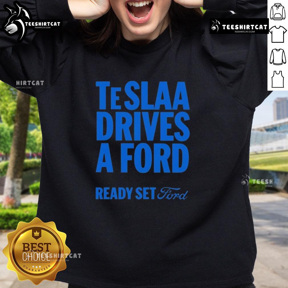 Top Tesla drives a Ford in a stylish 'Ready Set Ford' sweatshirt, showcasing unique automotive fashion.