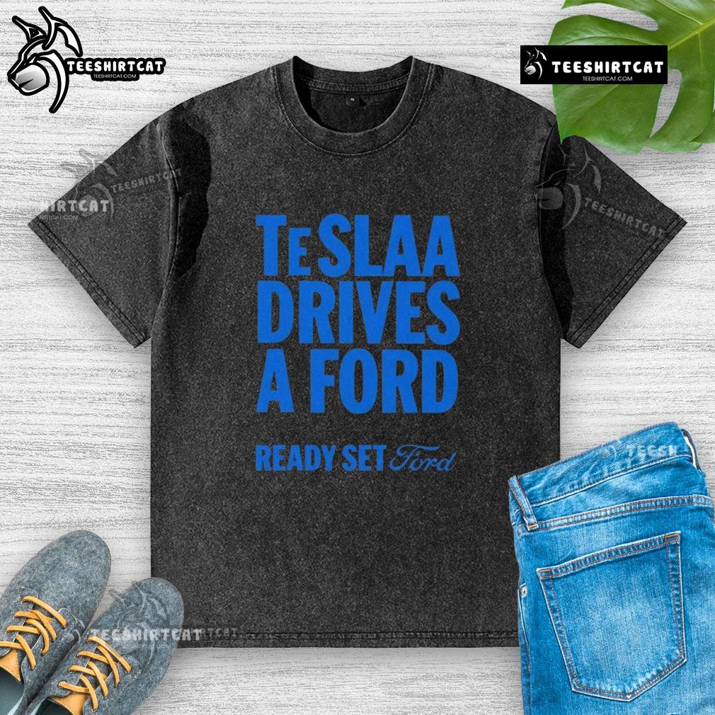 Alt Text: Top Tesla drives a Ford in a 'Ready Set Ford' washed t-shirt, showcasing a fun automotive twist and style.