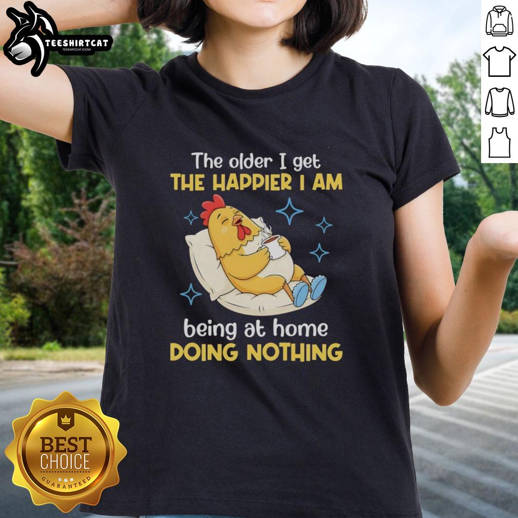 Nice ladies tee featuring 'The Older I Get, The Happier I Am Being at Home Doing Nothing' design in a cozy setting.