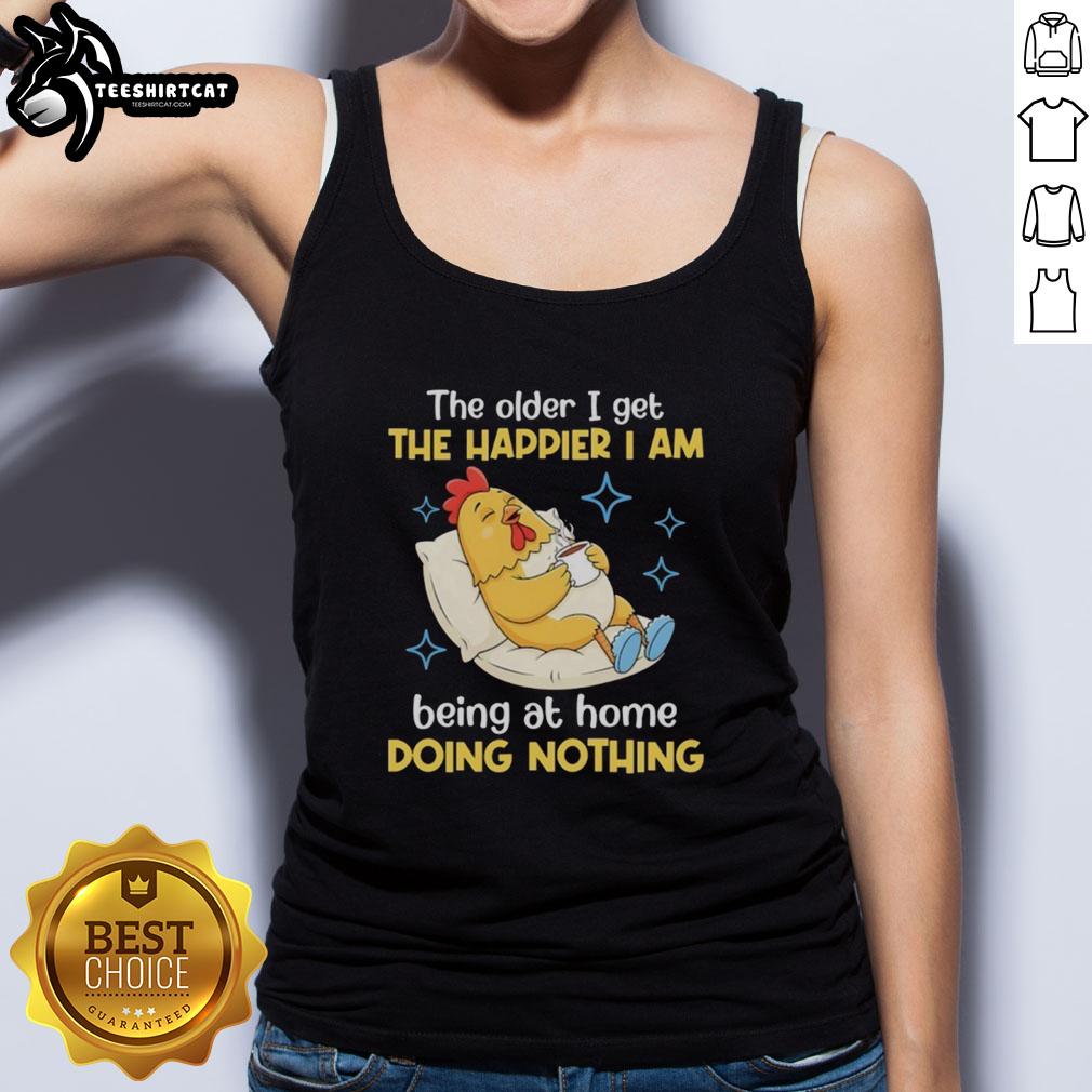 Alt Text: Woman wearing 'The Older I Get The Happier I Am Being At Home Doing Nothing' tank top, relaxed at home.