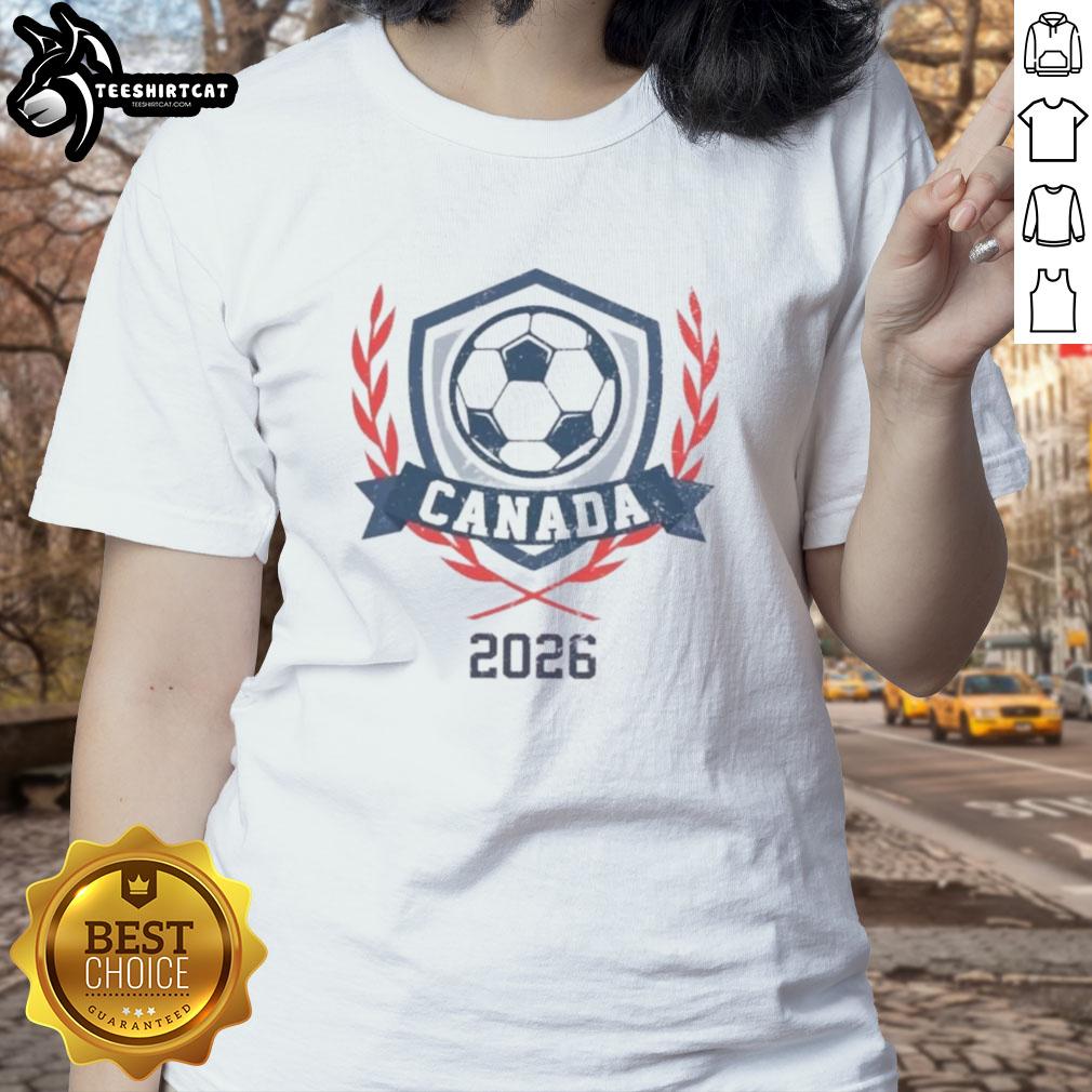 Alt Text: Vintage Canada 2026 soccer crest on a ladies tee, showcasing official design and vibrant colors for soccer fans.