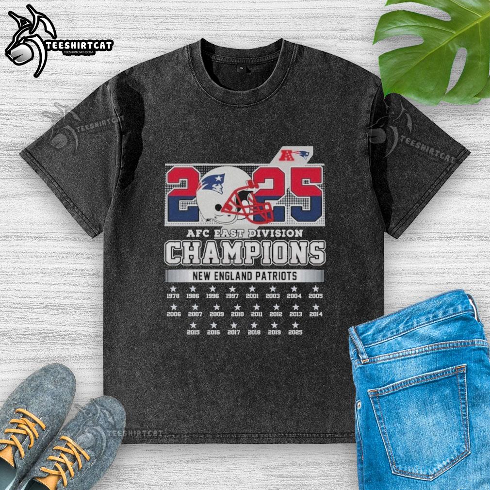 Alt Text: Official New England Patriots 2025 AFC East Division Champions helmet graphic on a washed t-shirt, showcasing team pride.