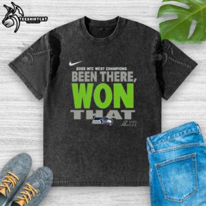Alt Text: Official Seattle Seahawks 2025 NFC West Champions washed t-shirt featuring team logo and championship graphics.