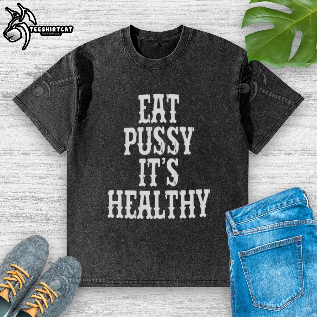 Alt Text: Original Rockstar Eat Pussy It's Healthy washed t-shirt featuring bold graphic print on a stylish design.