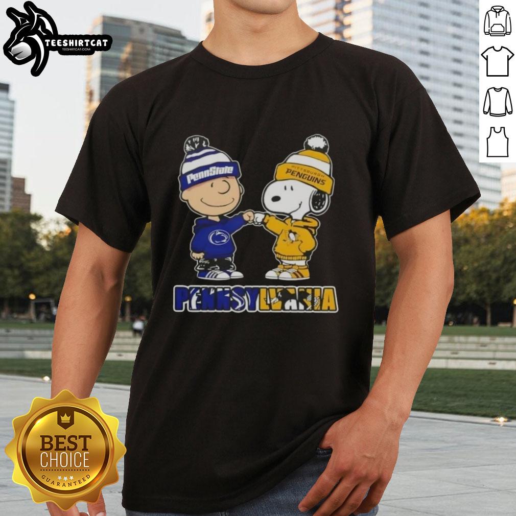 Charlie Brown fist bump with Snoopy on a Nittany Lions and Penguins T-shirt, perfect for Pittsburgh fans.