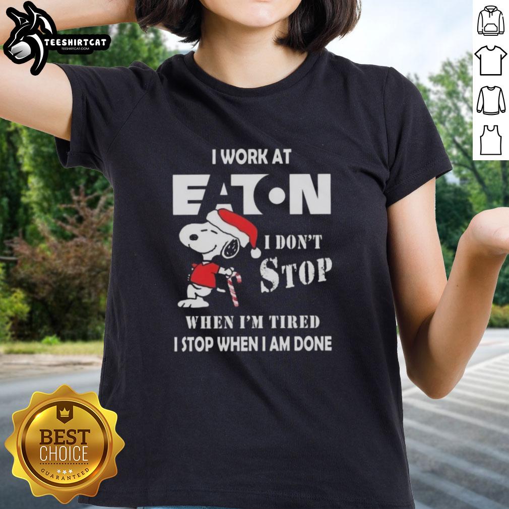 Alt Text: Top Snoopy I Work At Eaton Corporation Christmas Ladies Tee with motivational quote and festive design.