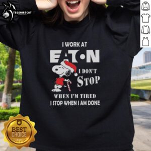 Alt Text: Top Snoopy Christmas sweatshirt featuring 'I work at Eaton Corporation, I don't stop when I'm tired' slogan.