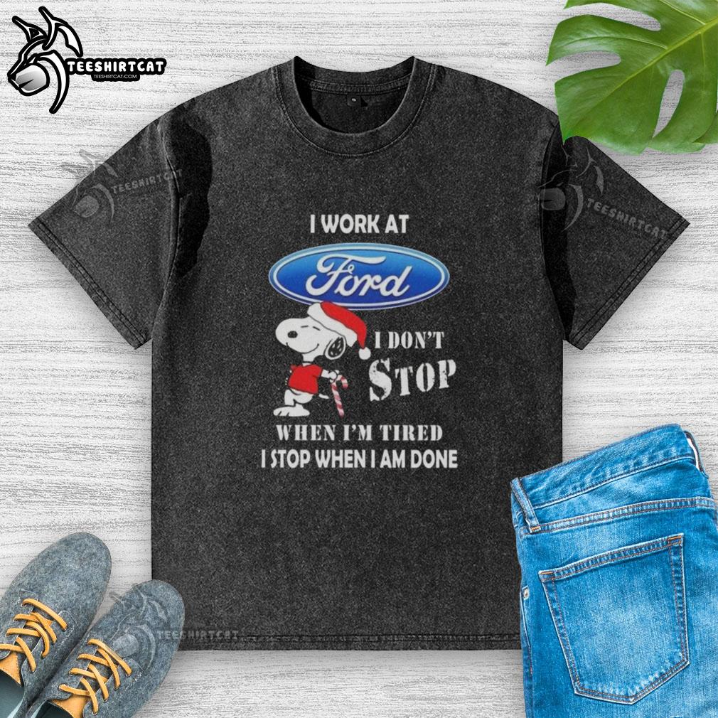 Alt Text: Top Snoopy I Work At Ford Motor T-Shirt - Christmas design with Snoopy saying 'I don't stop when I'm tired.'