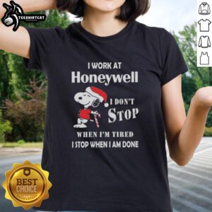 Alt Text: Snoopy graphic t-shirt for women: 'I work at Honeywell, I don't stop when I'm tired, I stop when I'm done' Christmas design.