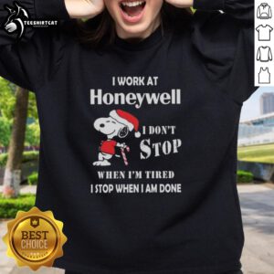 Snoopy Christmas sweatshirt featuring 'I work at Honeywell, I don't stop when I'm tired, I stop when I'm done' design.