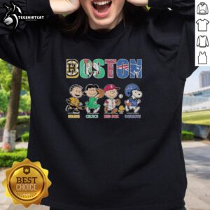 Alt Text: Cozy sweatshirt featuring Peanuts characters with logos of Boston Bruins, Celtics, Red Sox, and Patriots.