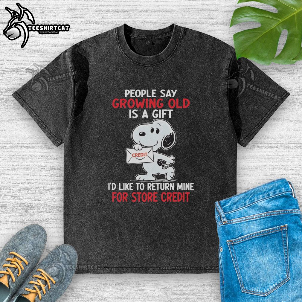 Funny Snoopy t-shirt saying 'Growing old is a gift I'd like to return for store credit' on a washed fabric.