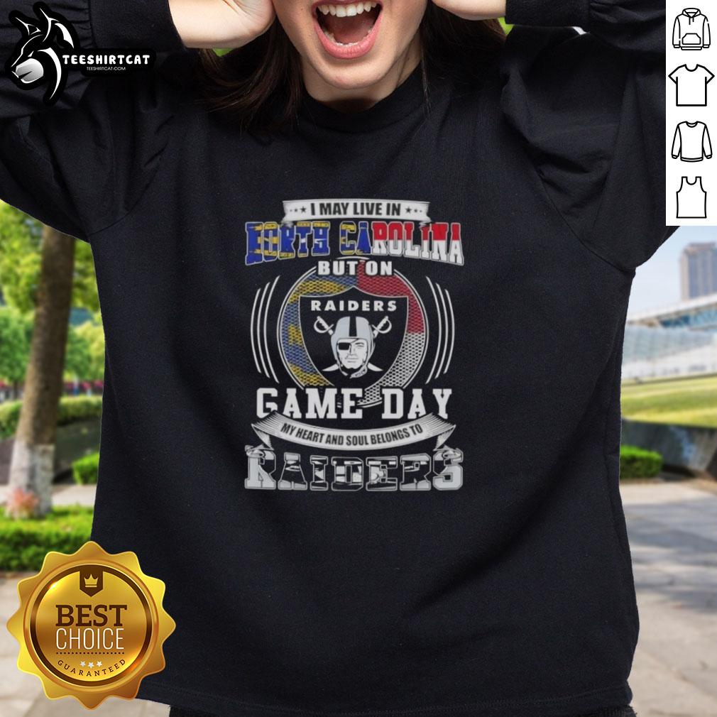 Alt Text: North Carolina fan wearing Las Vegas Raiders sweatshirt, showcasing team pride on game day.