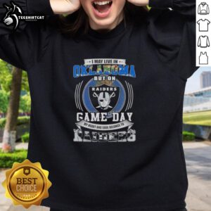 Alt Text: Cozy sweatshirt featuring 'I May Live In Oklahoma But On Game Day My Heart Belongs To Las Vegas Raiders' design.