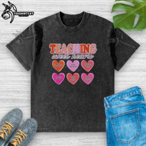 Child wearing a washed t-shirt promoting inclusivity and respect, learning through play in a vibrant classroom setting.