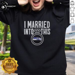 Woman wearing a Seattle Seahawks sweatshirt with 'Hot I Married Into This' slogan, showcasing team spirit and style.