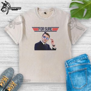 Emmanuel Macron in a washed t-shirt featuring the Top Gun logo, showcasing a casual style and political flair.