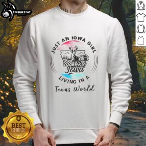 Cozy Top Just An Iowa Girl Living In A Texas World Sweatshirt displayed on a wooden background, perfect for casual wear.