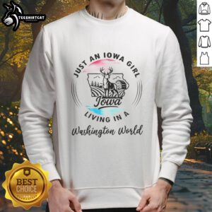 Cozy 'Just An Iowa Girl Living In A Washington World' sweatshirt displayed on a mannequin against a rustic backdrop.