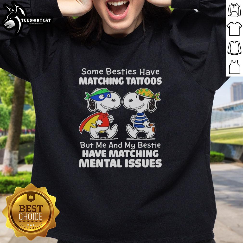 Besties in matching sweatshirts celebrating mental health awareness with a Snoopy design, showcasing friendship and support.
