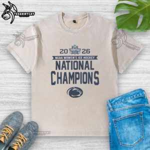 Alt Text: Official Penn State Nittany Lions Frozen Four Champions 2026 washed t-shirt displayed on a wooden background.