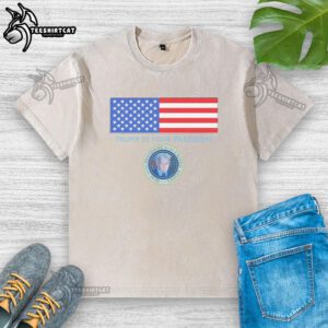 Official Trump Is Your President flag and coat of arms design on a washed t-shirt for patriotic supporters.