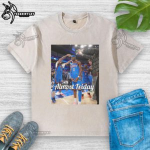 Shai Gilgeous-Alexander in an Oklahoma City Thunder 'Almost Friday' postgame washed t-shirt, showcasing team spirit.