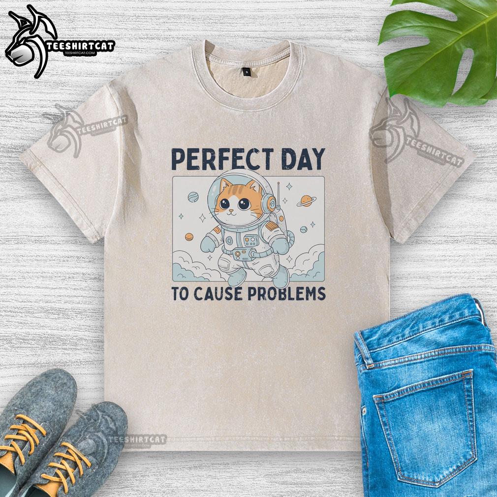 Astronaut cat in a 'Nice Perfect Day to Cause Problems' washed t-shirt, showcasing a playful and whimsical vibe.