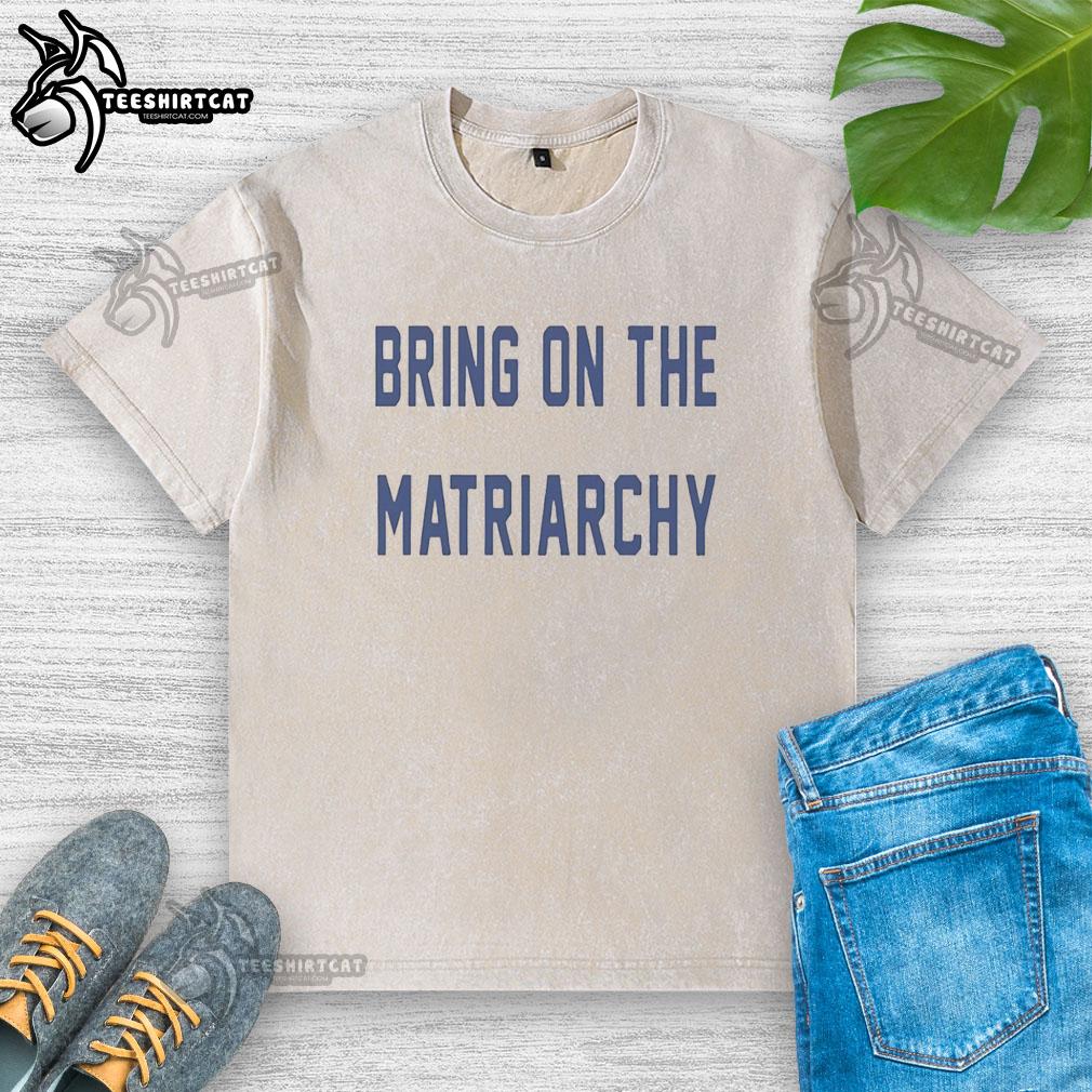 Alt Text: Official 'Bring On The Matriarchy' F1 washed t-shirt showcasing the youngest championship leader at the 2026 Japanese Grand Prix.