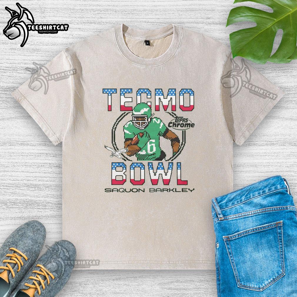 Alt Text: Official Tecmo Bowl X Topps Chrome Eagles Saquon Barkley washed t-shirt featuring vibrant team graphics.