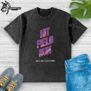 Pretty Hit Field Run Nico Does Everything washed t-shirt displayed on a wooden background, showcasing its stylish design.
