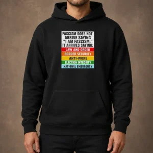 Original Fascism Does Not Arrive Saying I Am Fascism It Arrives Saying Law And Order Hoodie in dark color with front pocket and hood